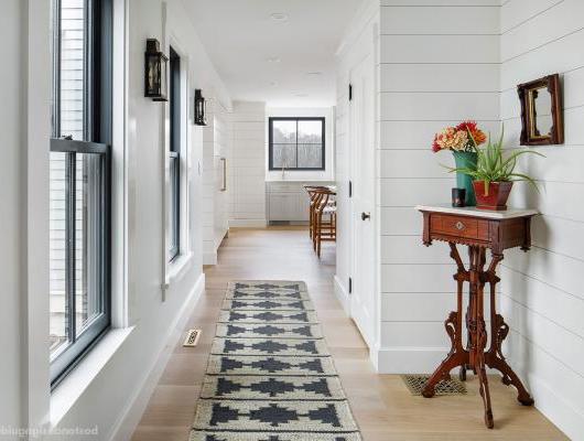 Nickel gap wood paneling lines a custom hallway by McCormack Builders